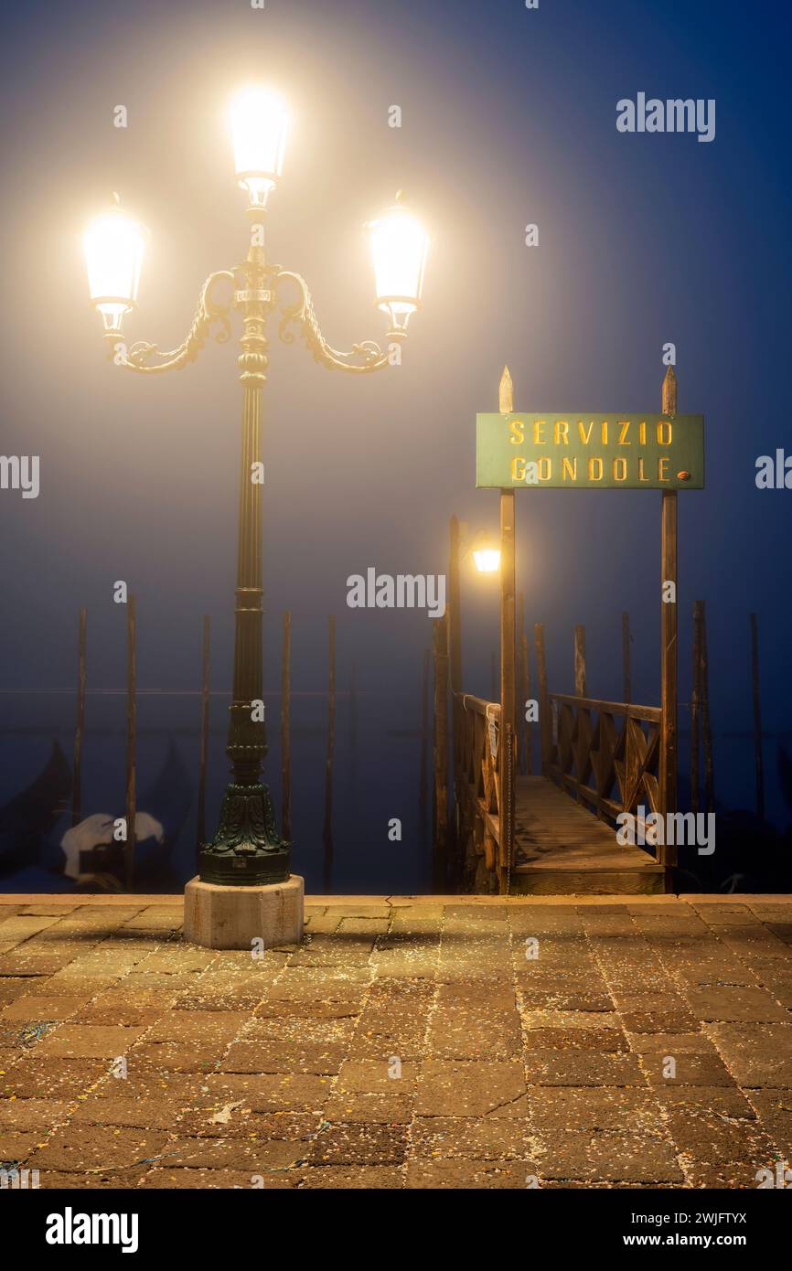 Gondola service sign in a foggy night, Venice, Veneto, Italy Stock Photo