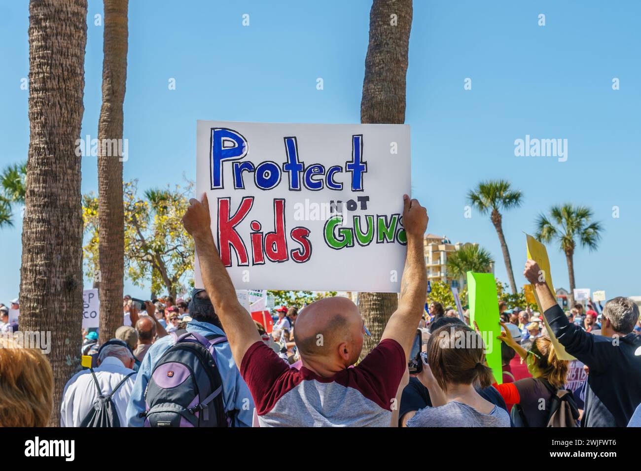 Sarasota, FL, US -March 24, 2018 - Protesters gather at the student-led protest March For Our Lives holding sign reading 'Protect Kids Not Guns' Stock Photo