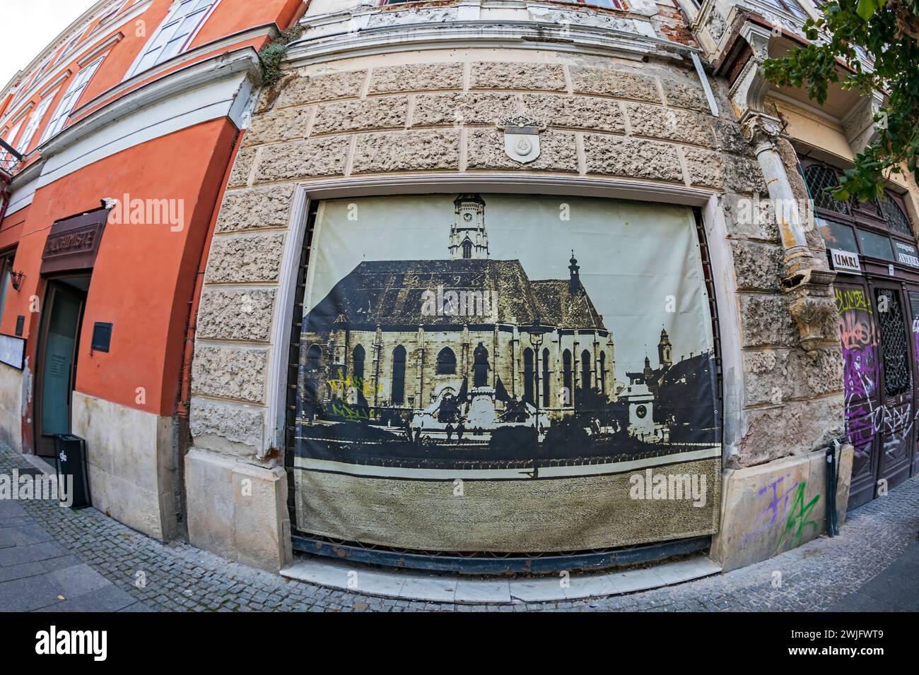 CLUJ-NAPOCA, ROMANIA - SEPTEMBER 20, 2020: Facade of a historic building located in the historic center, with banner in the form of photographs which Stock Photo