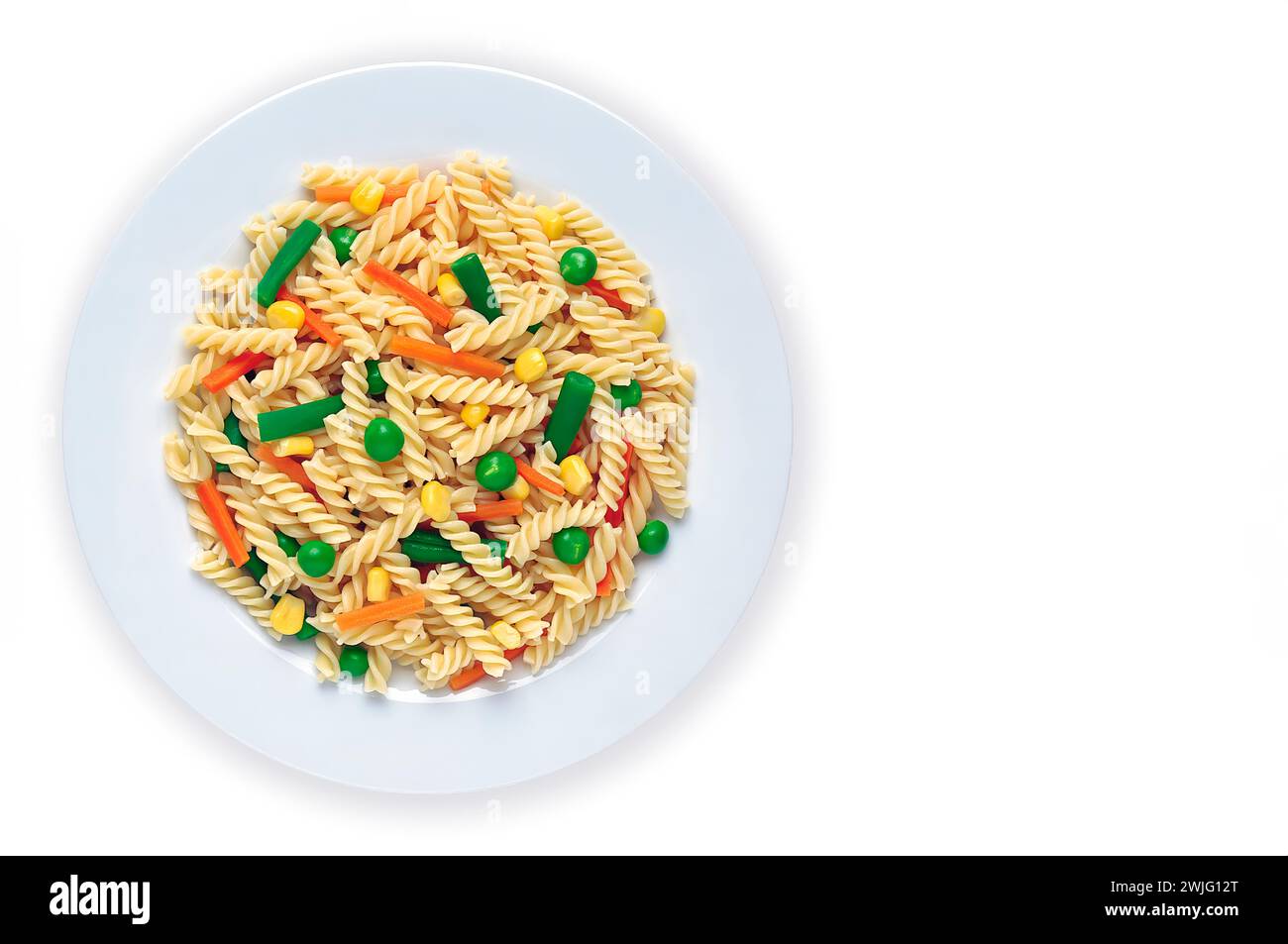 Still life with pasta dish with peas, green beans and carrots, on white background. Stock Photo