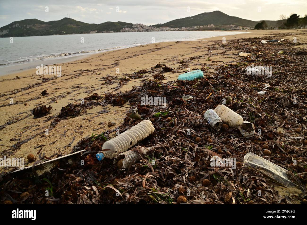 Garbage beach after a storm with a lot of marine sediment and plastic waste on the coast of the Mediterranean Sea. Environmental protection problem. Stock Photo