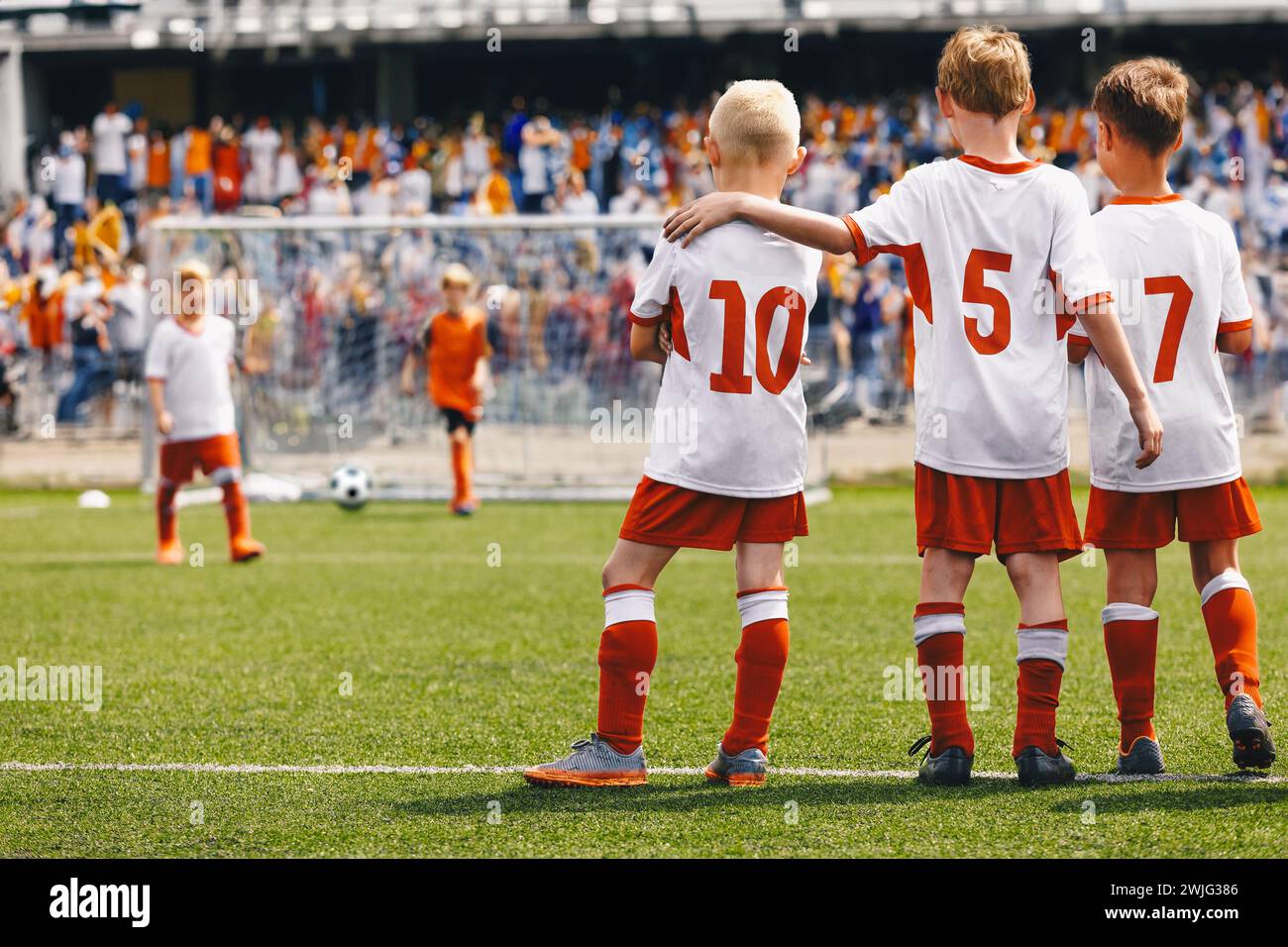 School Boys as Soccer Friends Teammates. Kids United in a Sports Team During Penalty Kick Game. Children in Football Uniforms at a Sports Arena Playin Stock Photo