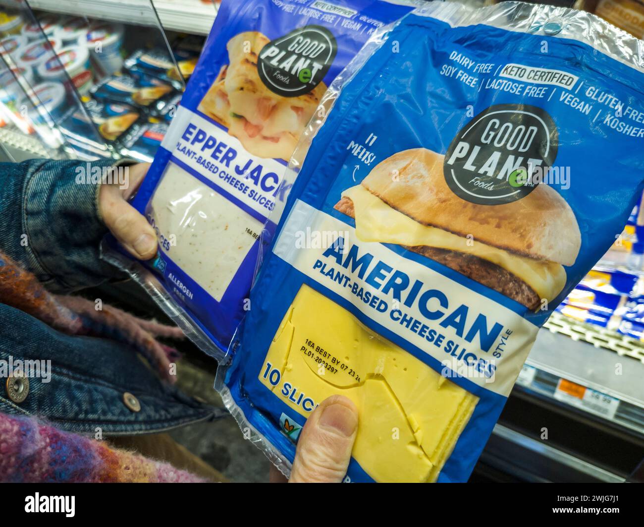 A shopper in a supermarket in New York chooses packages of Good Planet brand plant-based 'cheese' in a supermarket in New York on Friday, February 9, 2024. (© Richard B. Levine) Stock Photo