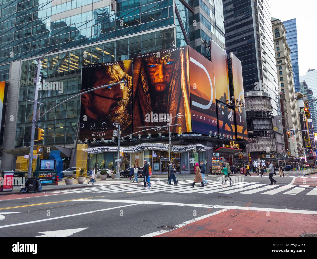 Hordes of people cross West 42nd Street under advertising for the Warner Bros. PicturesÕ  ÒDune: Part TwoÓ film in Times Square in New York on Sunday, February 11, 2024. The film is slated to be released March 1. (© Richard B. Levine) Stock Photo