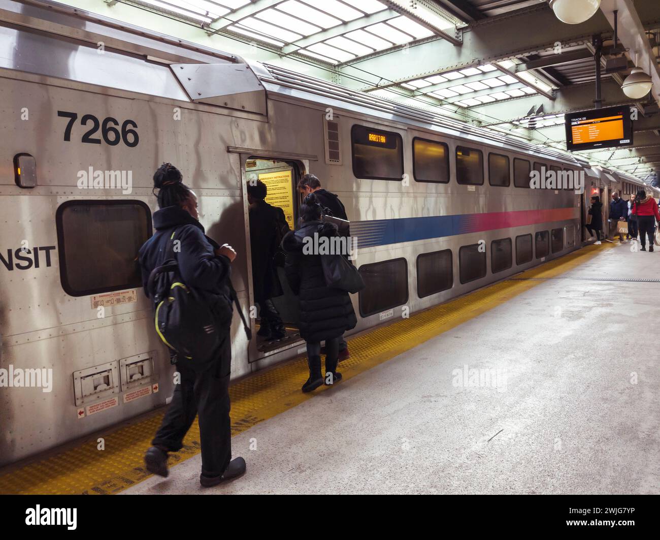 Passengers board a New Jersey Transit train on the Raritan line at Newark Penn Station on Saturday, February 10, 2024. (© Richard B. Levine) Stock Photo