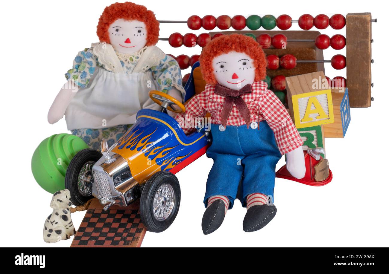 Raggedy Ann & Andy, old handmade rag dolls, sit surrounded with vintage ...