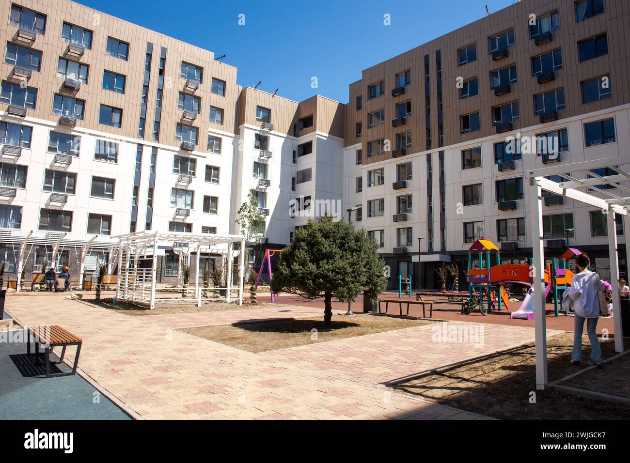 Modern apartment buildings with a courtyard playground. Contemporary