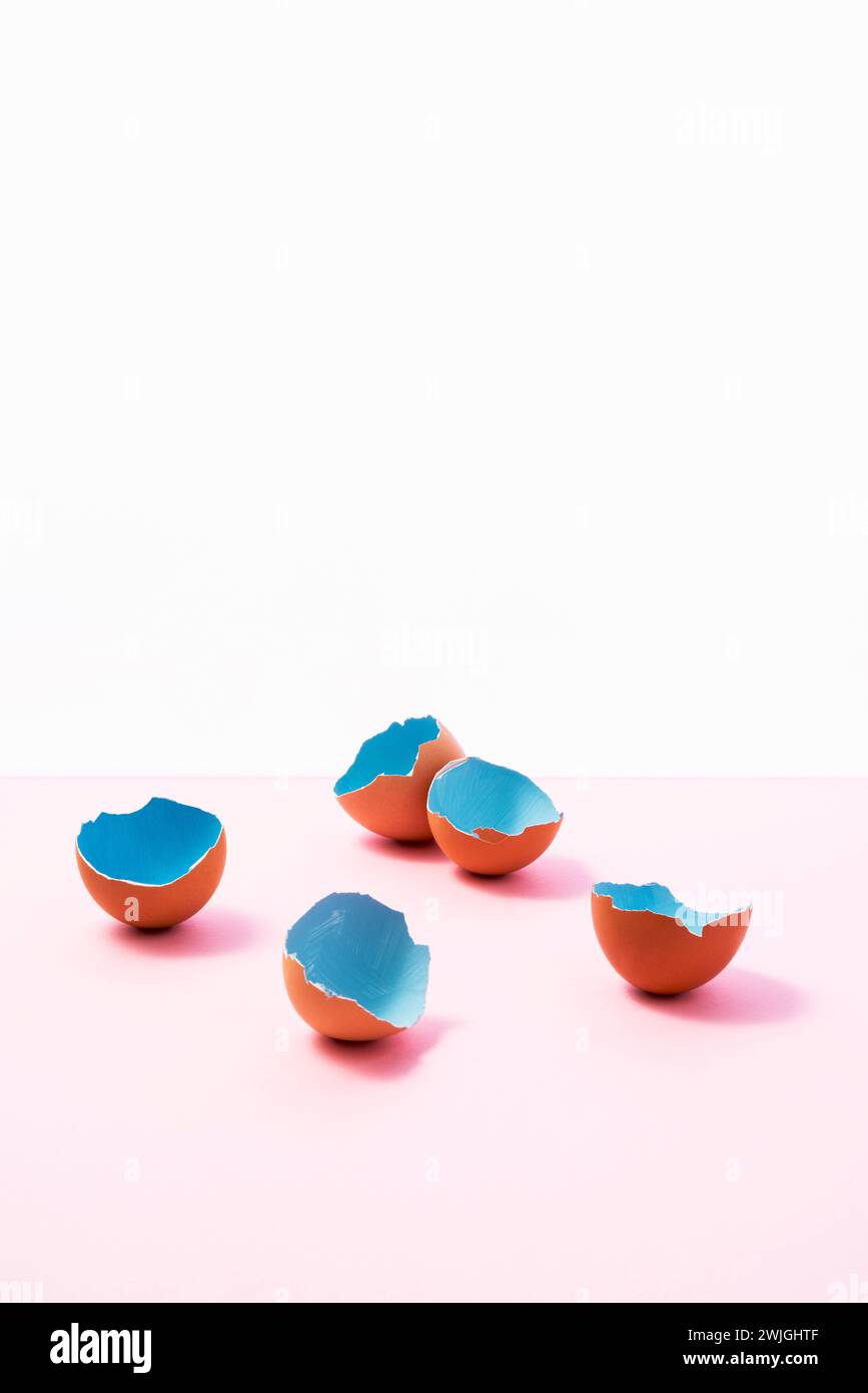 Blue painted easter eggs shells on pink, and white background Stock Photo