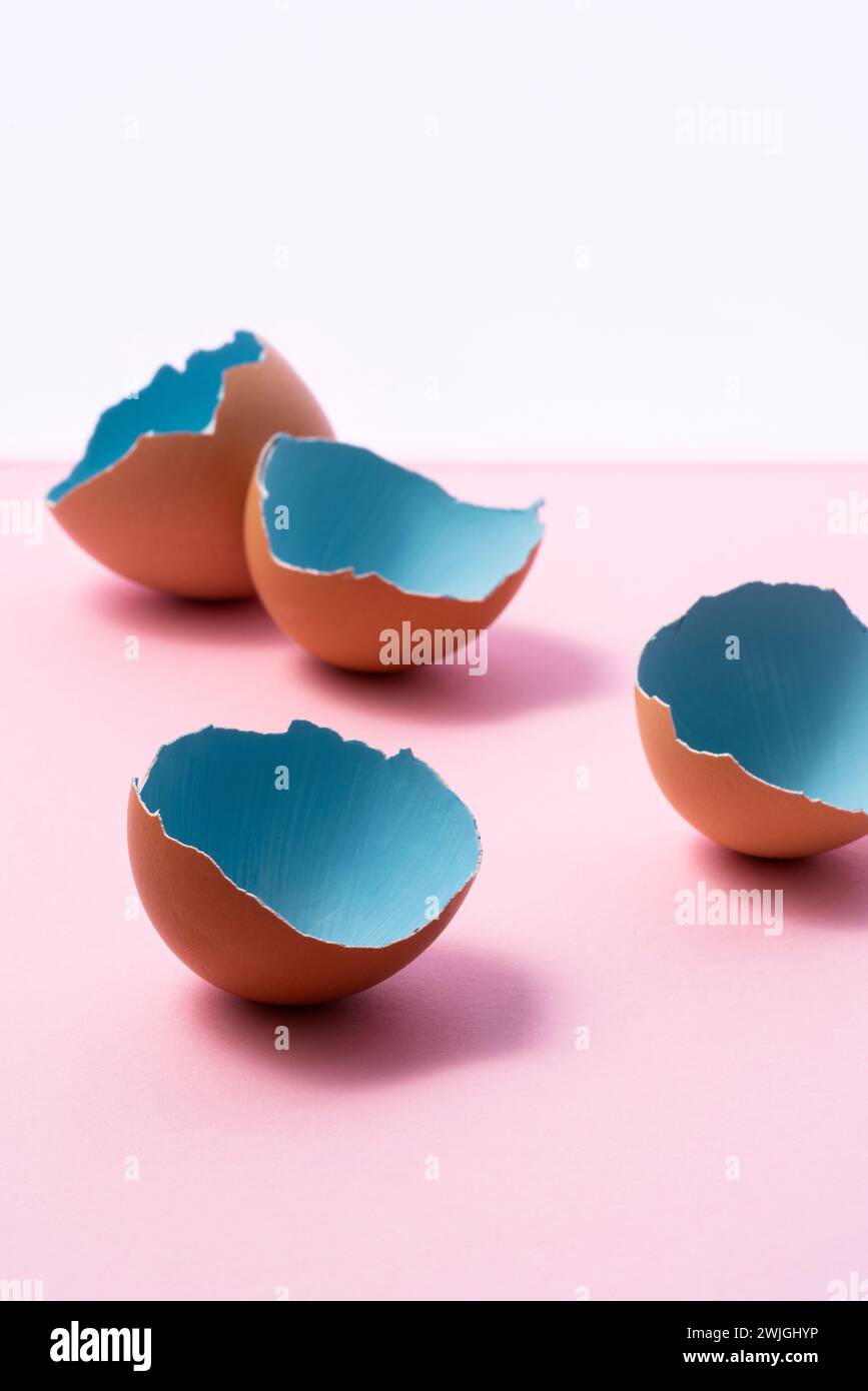 Blue painted easter eggs shells on pink, and white background Stock Photo