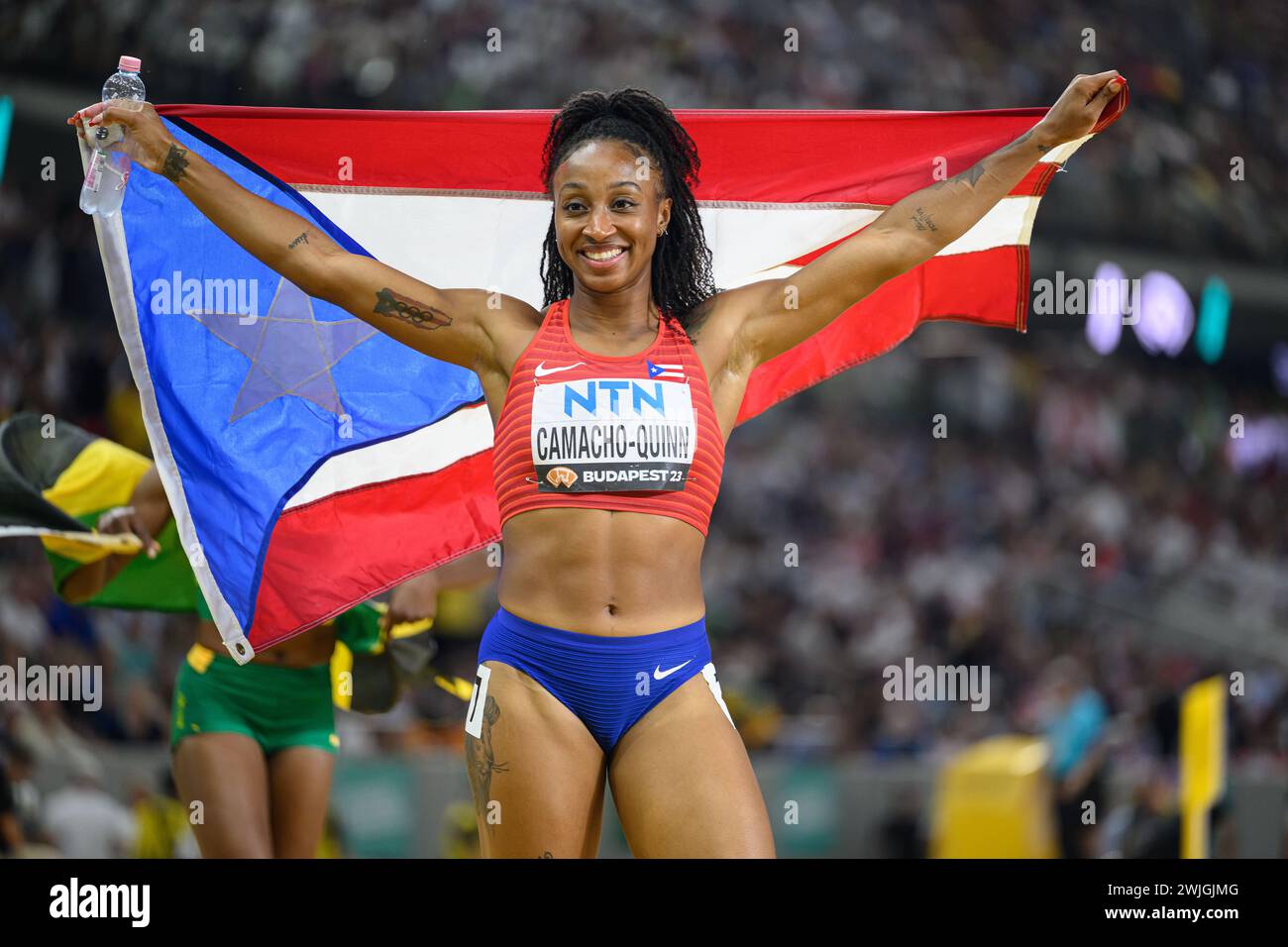 Jasmine CAMACHOQUINN celebrating his medal with the flag in the