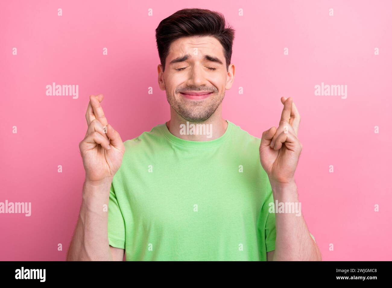 Photo of young person guy closed eyes crossed two hands fingers begging ...