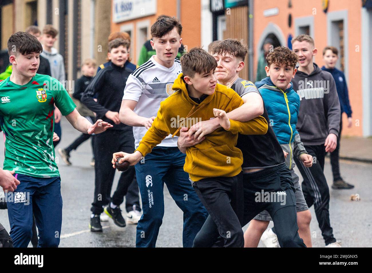Youths take part in the annual 'Hand ba' is played in Scottish borders town Jedburgh. Traditionally the first ever game was played with an Englishman’s head,  the ribbons on the ball symbolise his hair. The teams (Uppies and Doonies) are chosen by where they live – Uppies are those born to the South and Doonies to the North of the Market Cross.  Credit: Euan Cherry Stock Photo