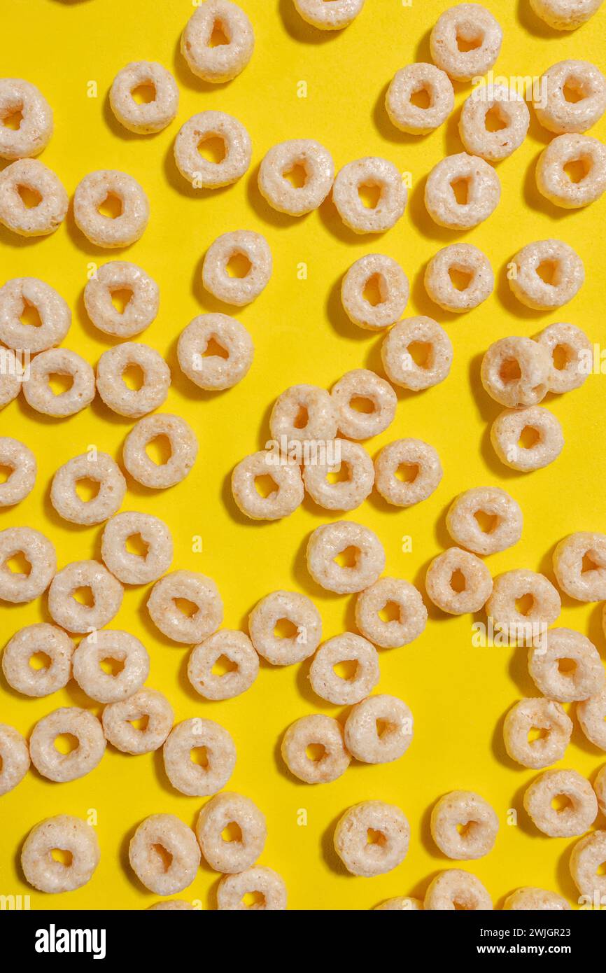 Circle shape cereals on bright yellow background, top view Stock Photo ...