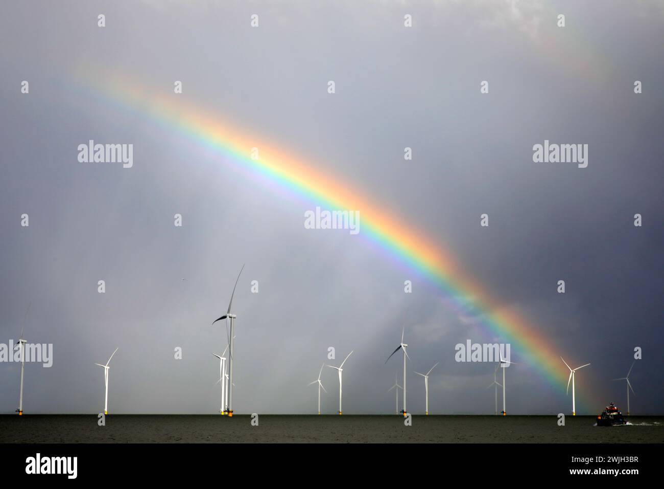 Rainbow above a offshore windpark, Breezanddijk, Holland Stock Photo