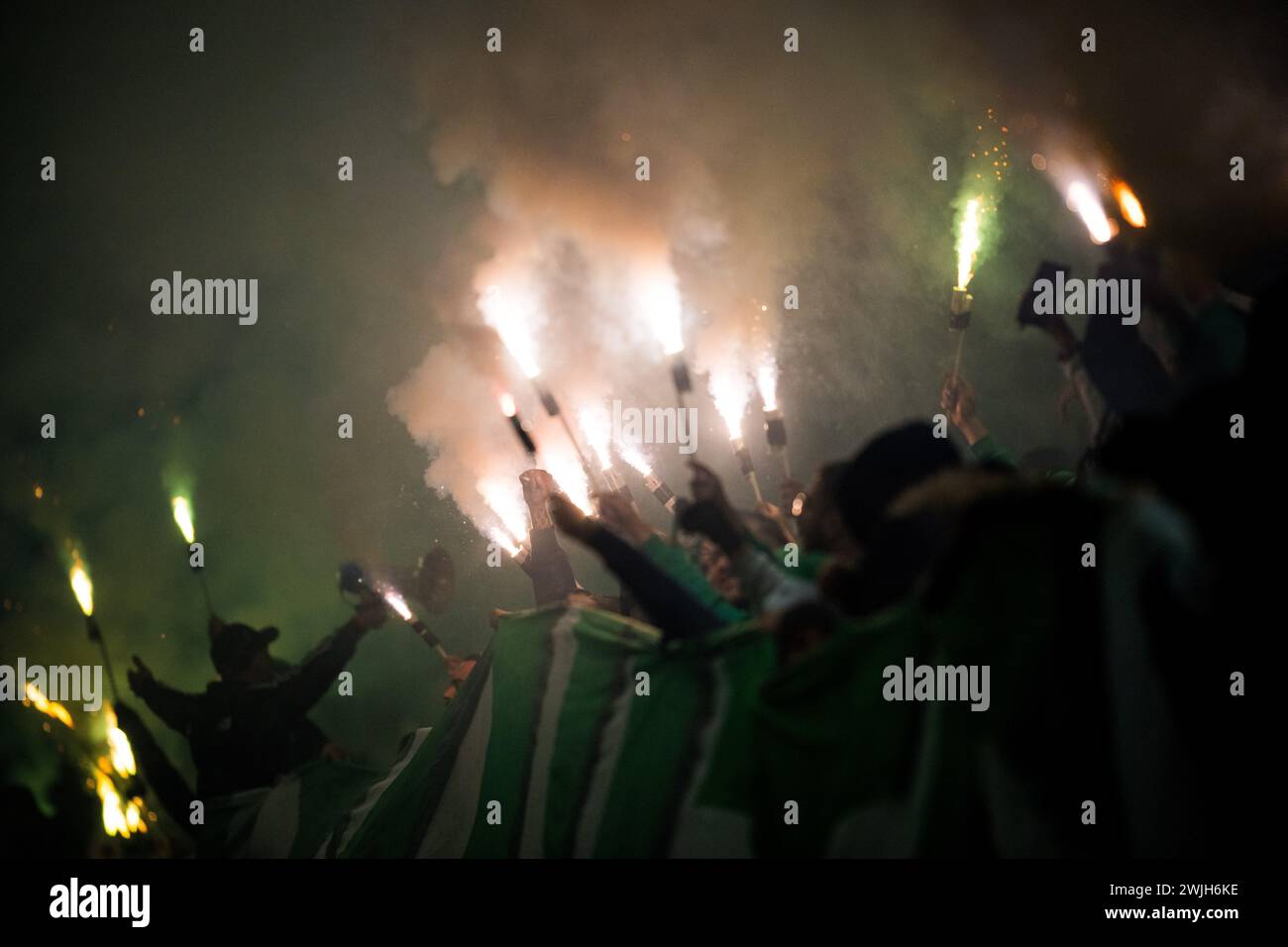 Budapest, Hungary. 15th Feb, 2024. Maccabi's fans are lighting fireworks during a soccer game between Israeli club Maccabi Haifa and Belgian KAA Gent, Friday 15 December 2023 in Budapest, Hungary, the first leg of the knockout round play-offs of the UEFA Conference League competition. BELGA PHOTO JASPER JACOBS Credit: Belga News Agency/Alamy Live News Stock Photo