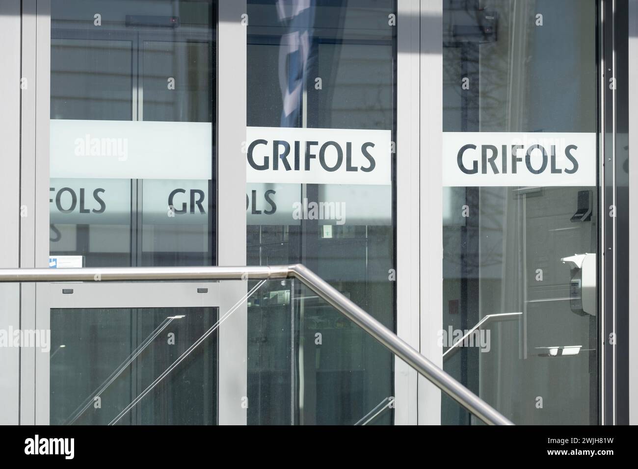 glass door office building with letters GRIFOLS, global healthcare ...