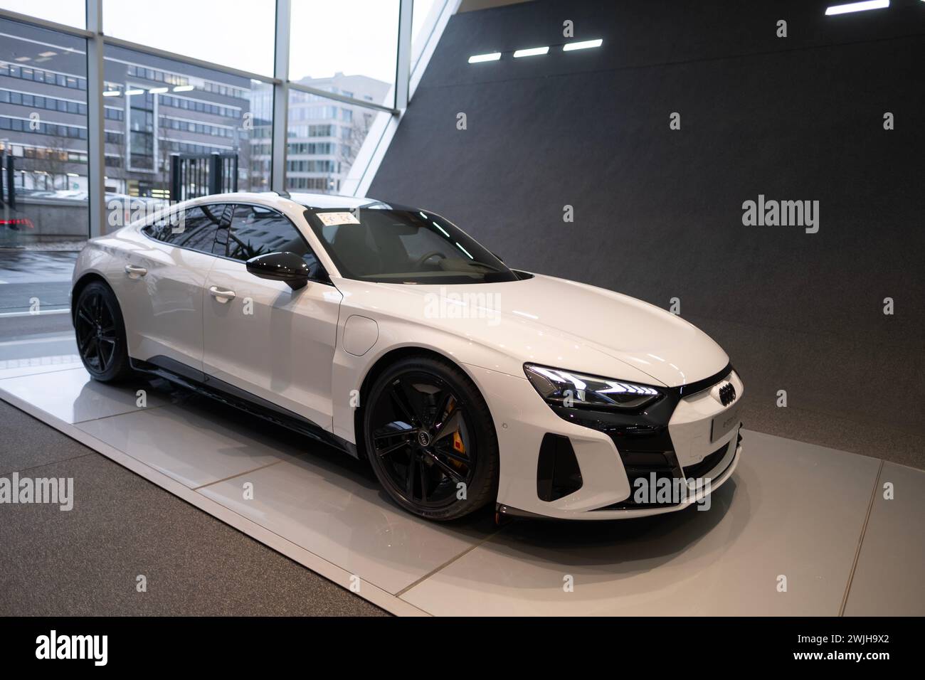 white new Luxury Electric Car Audi e-tron GT, limousine, four-door coupe in showroom, Automotive Innovation in automotive industry, Future Mobility sh Stock Photo