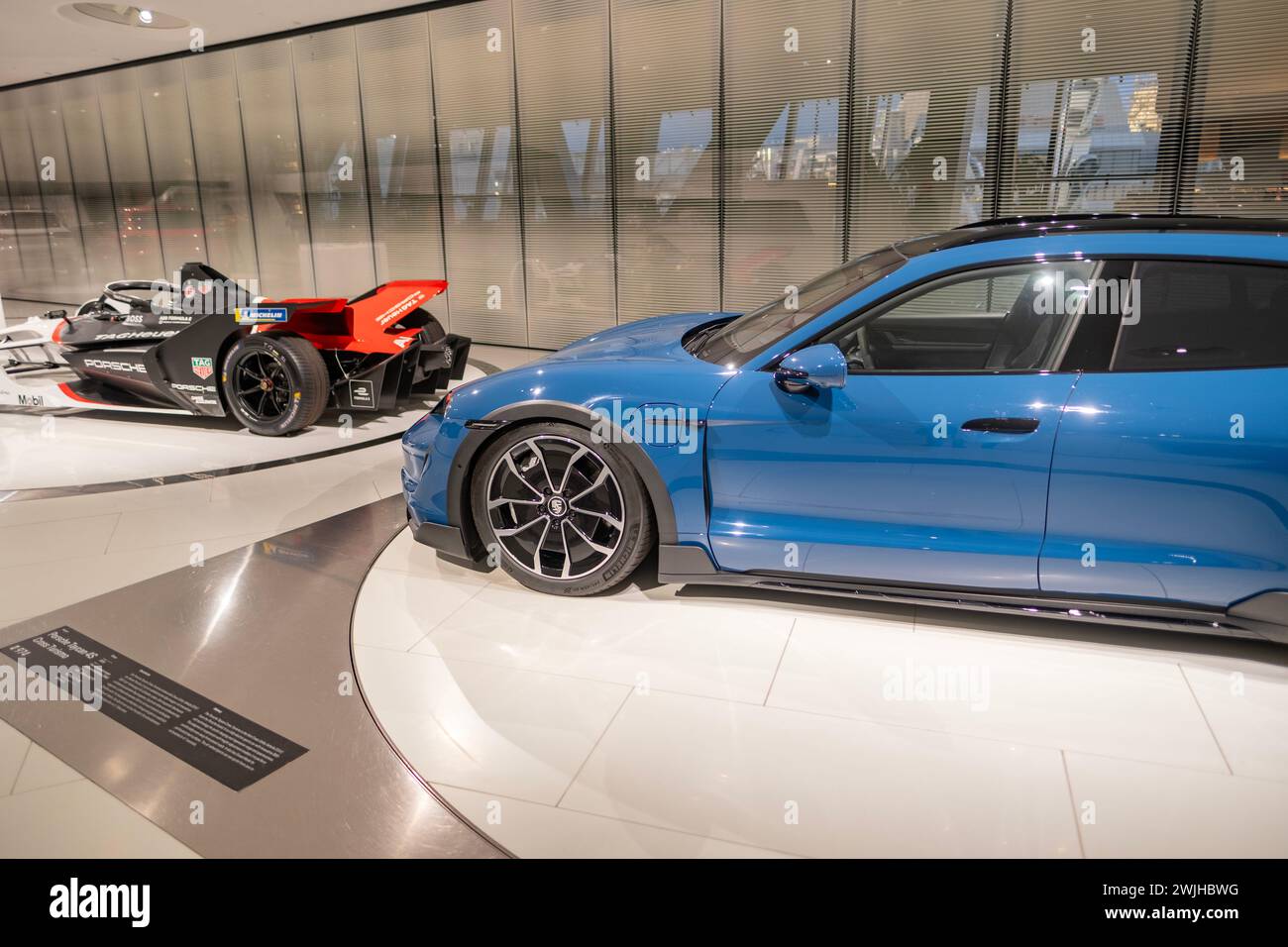 blue Porsche Taycan 4 Cross Turismo Electric Vehicle, battery-electric Car exhibition Museum Porsche, history and Innovation in automotive industry sh Stock Photo