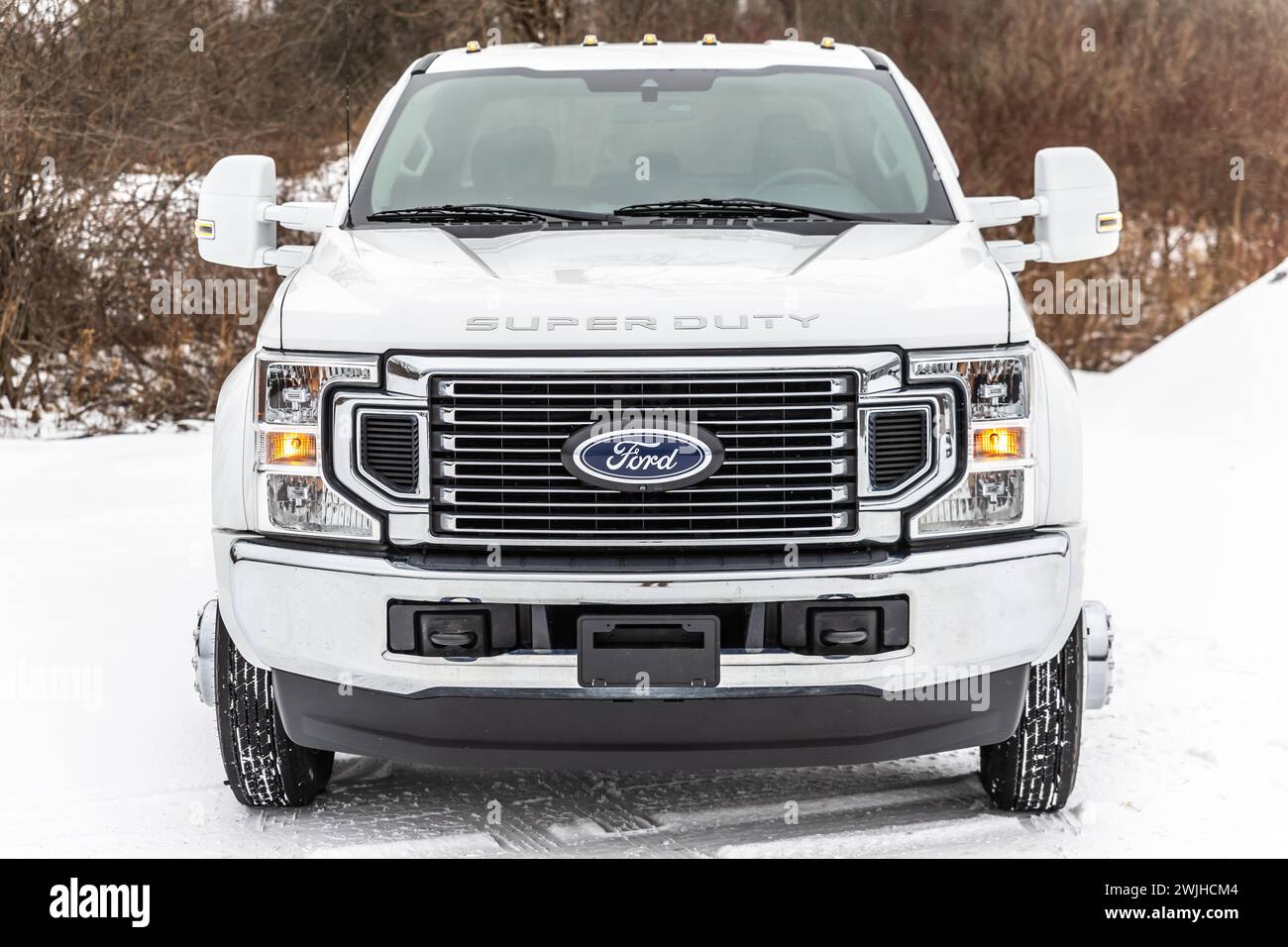 White Ford F250 truck parked in snowy landscape Stock Photo