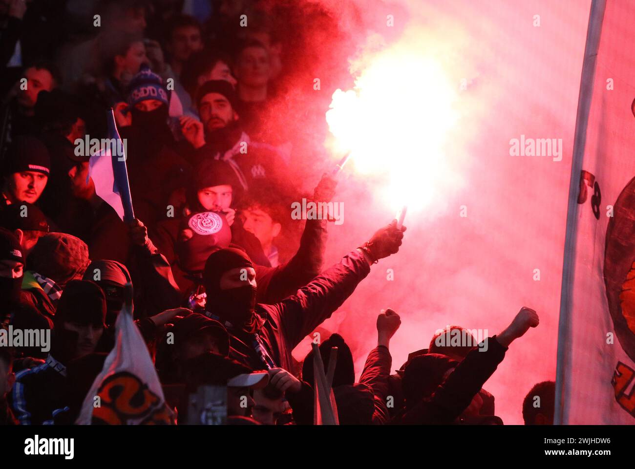 Hamburg, Germany - February 15, 2024: Marseille supporters burn flares and show their support during the UEFA Europa League game against Shakhtar Donetsk at Volksparkstadion in Hamburg, Germany Stock Photo