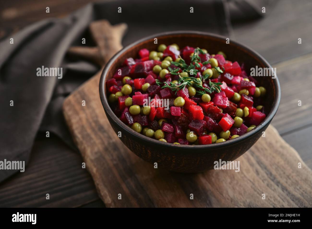 Vinegret - traditional Russian vegetable salad in bowl on wooden background, closeup Stock Photo