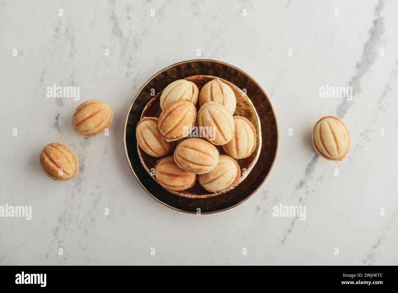 Homemade walnut shaped cookies with boiled condensed milk on white marble table, top view Stock Photo