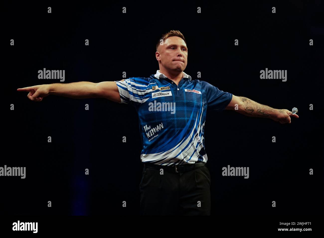Gerwyn Price reacts after beating Luke Littler (not pictured)during