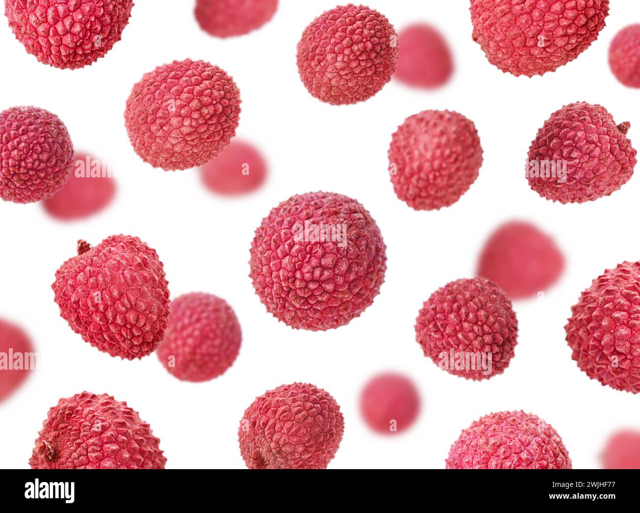 Falling lychee, isolated on white background, selective focus Stock Photo