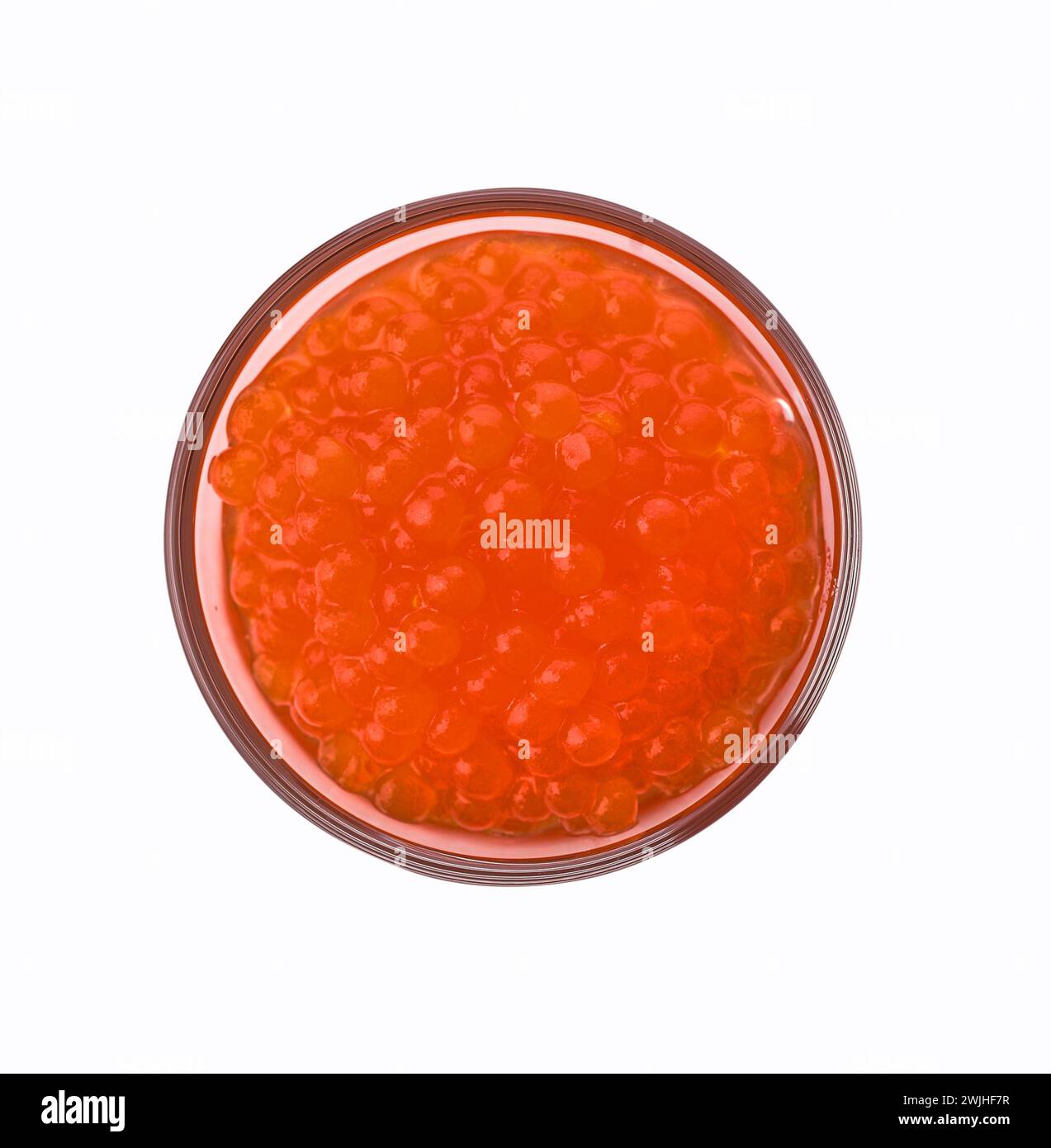 Glass of red trout caviar isolated on a white background, top view Stock Photo