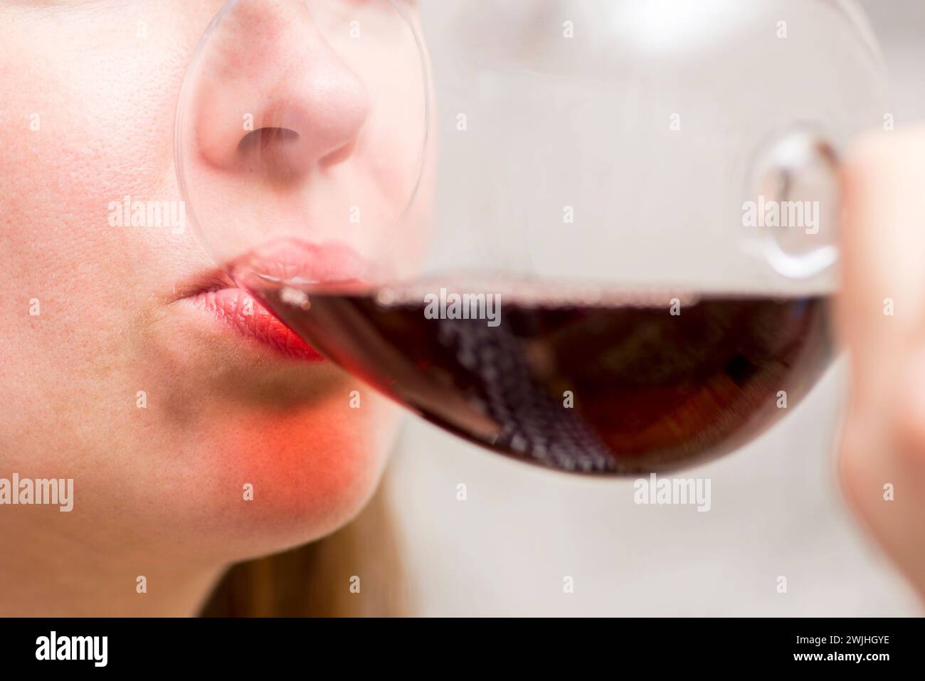 Close-Up of Woman Sipping Red Wine Stock Photo