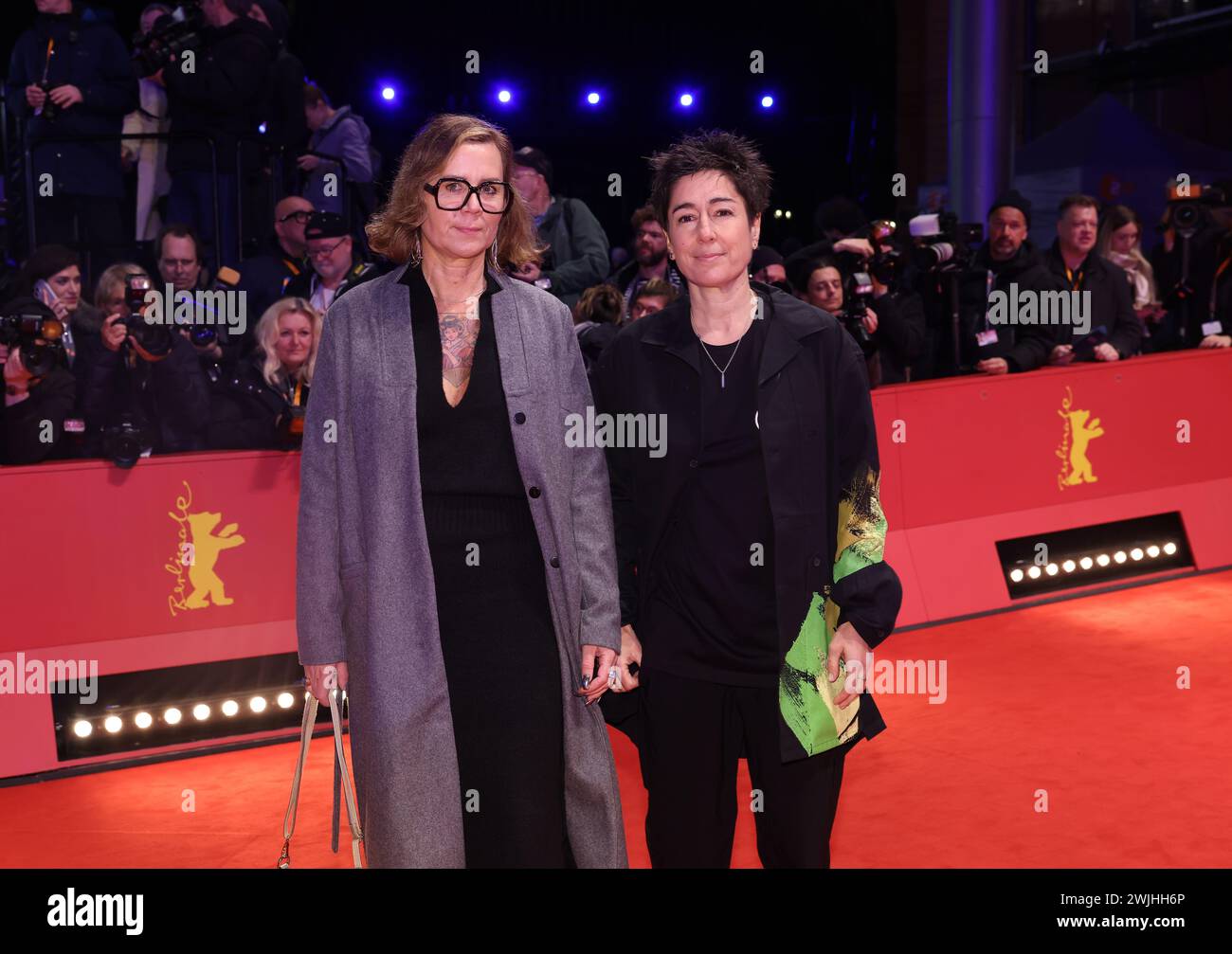 Berlin, Germany. 15th Feb, 2024. Dunja Hayali (r) and her partner Pamela Schobess walk the red
