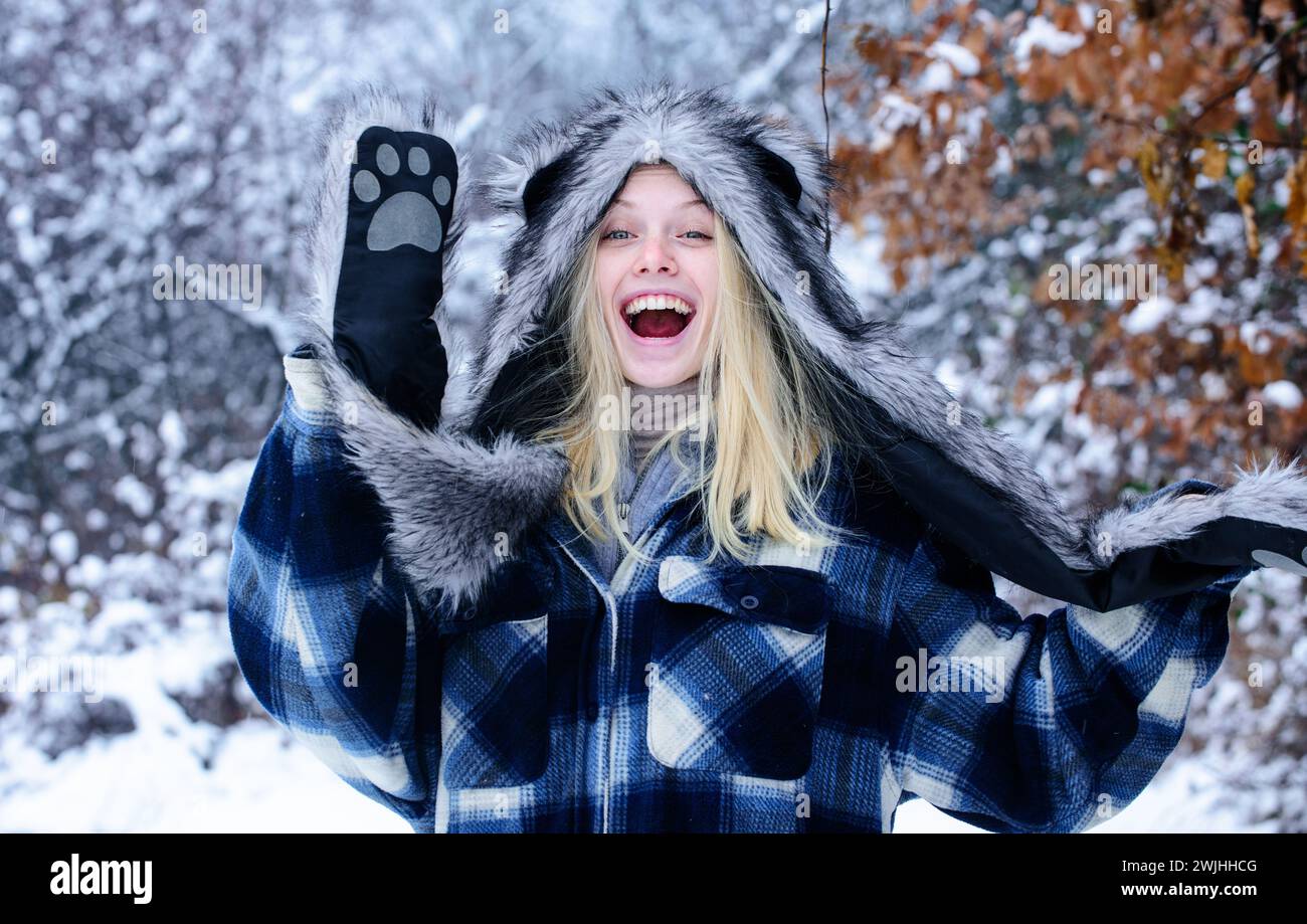 Wintertime. Happy woman in warm clothing in winter park. Winter activities. Fashionable girl in stylish winter wear. Beautiful blonde woman in plaid Stock Photo