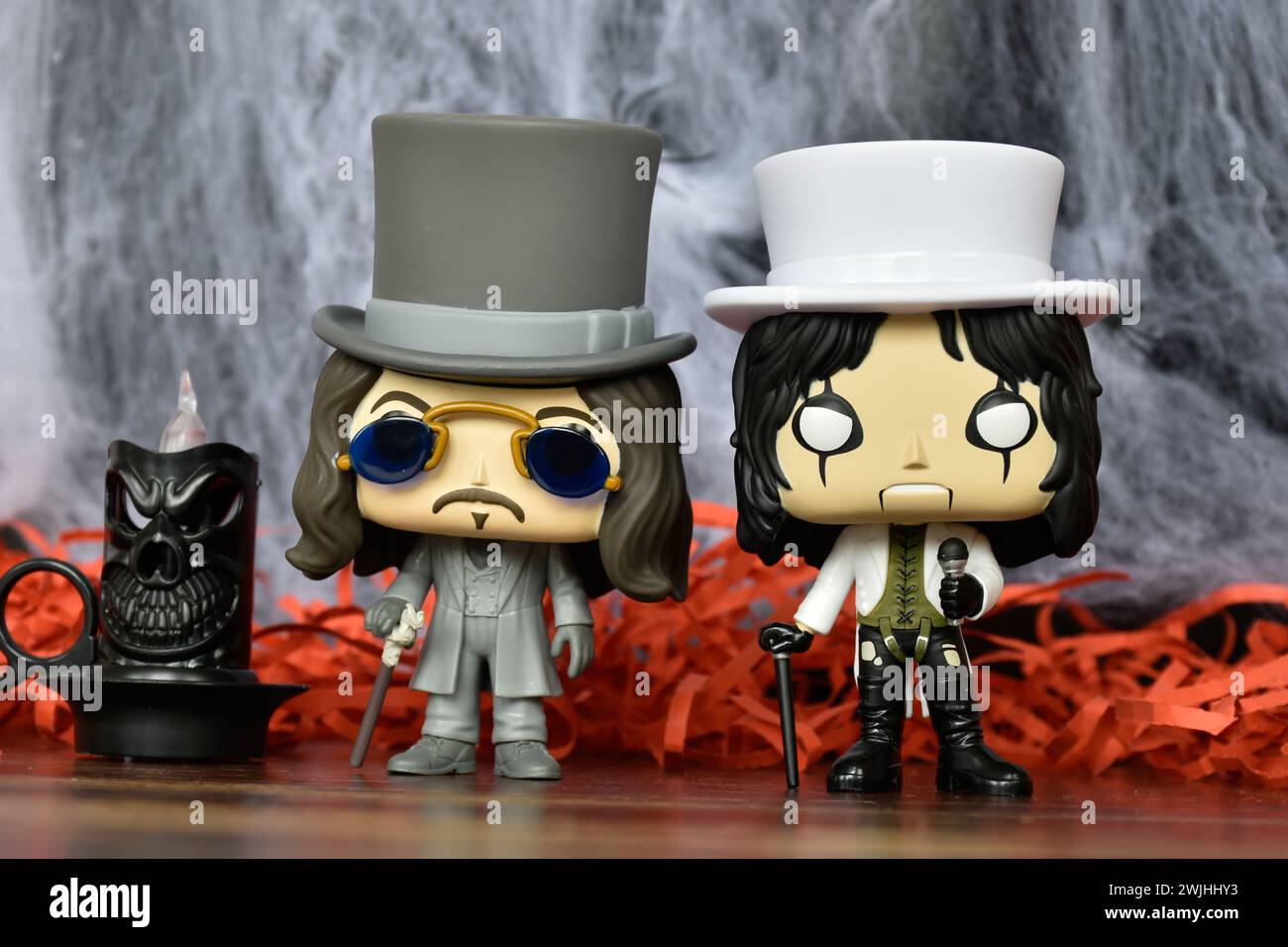 Funko Pop action figures of Bram Stoker's Dracula vampire and hard rock singer showman Alice Cooper. Spooky decor, black candle, gothic, horror mood. Stock Photo