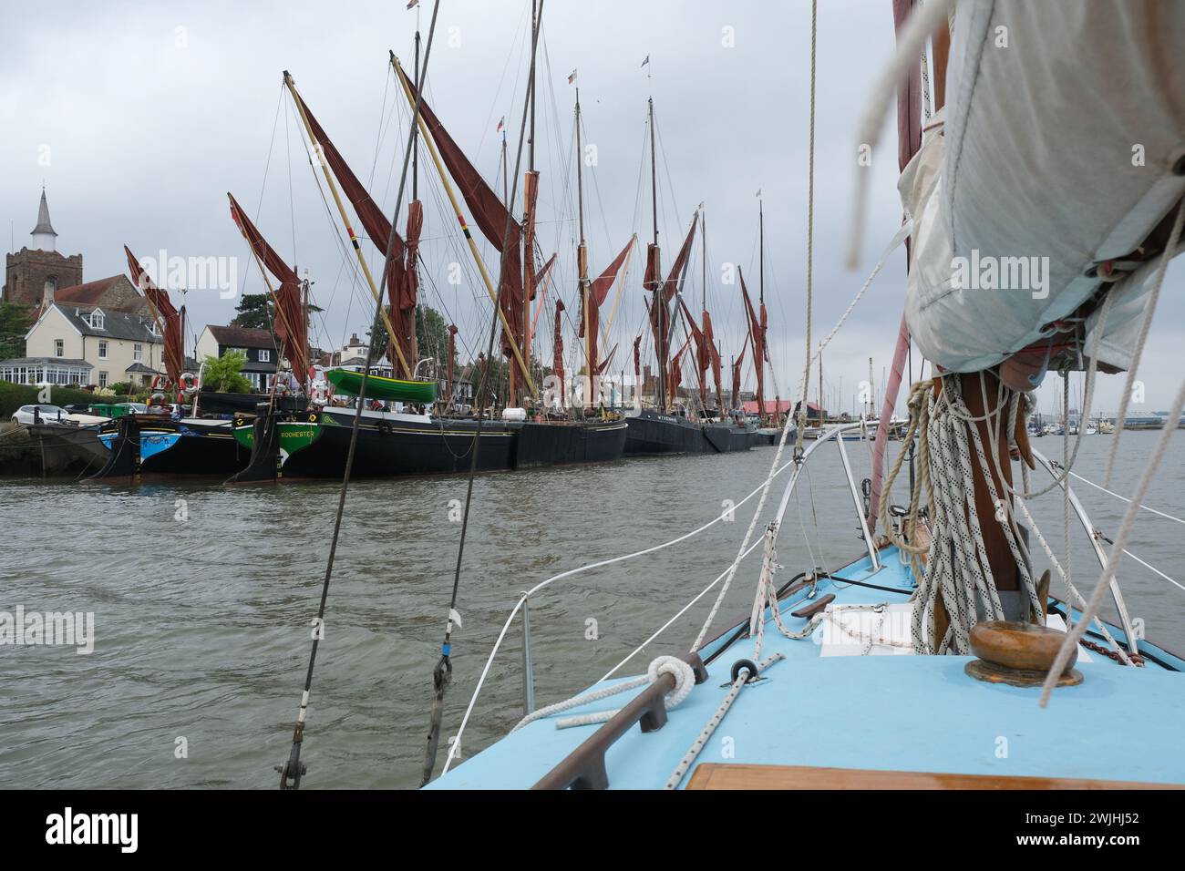 Thames barges moored at Maldon in Essex as seen from a sailing boat on the River Blackwater, Essex, UK Stock Photo