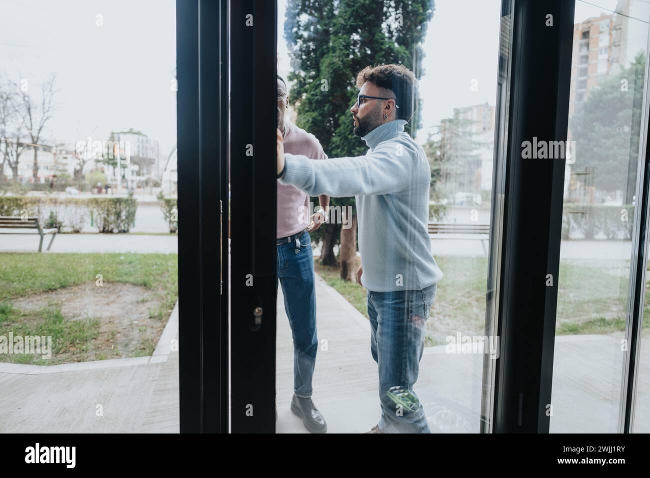 Multiracial people entering at hotel for check-in and registration ...