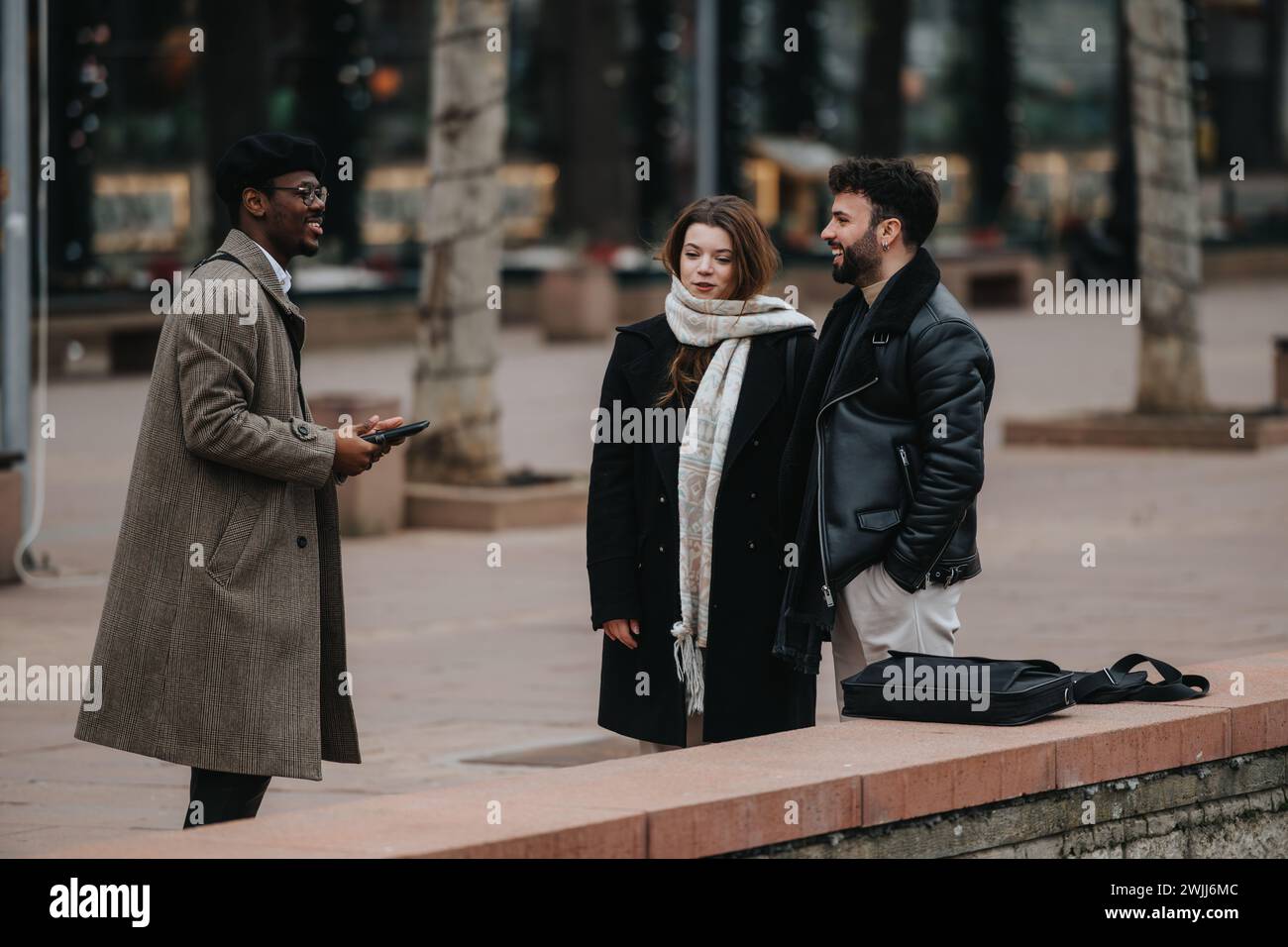 Urban business meeting: Young entrepreneurs discussing work outdoors. Stock Photo