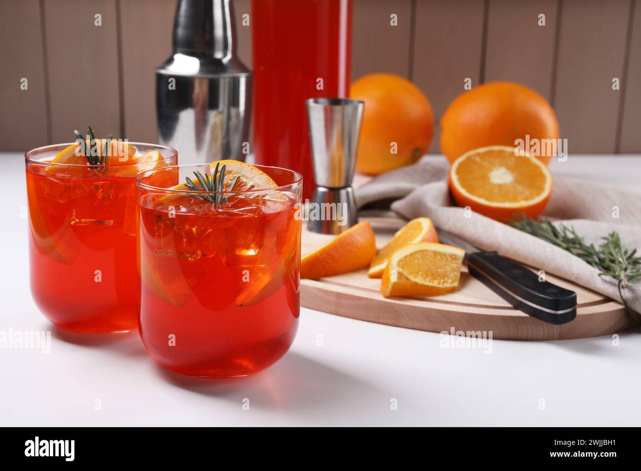 Aperol spritz cocktail, rosemary and orange slices on white wooden ...