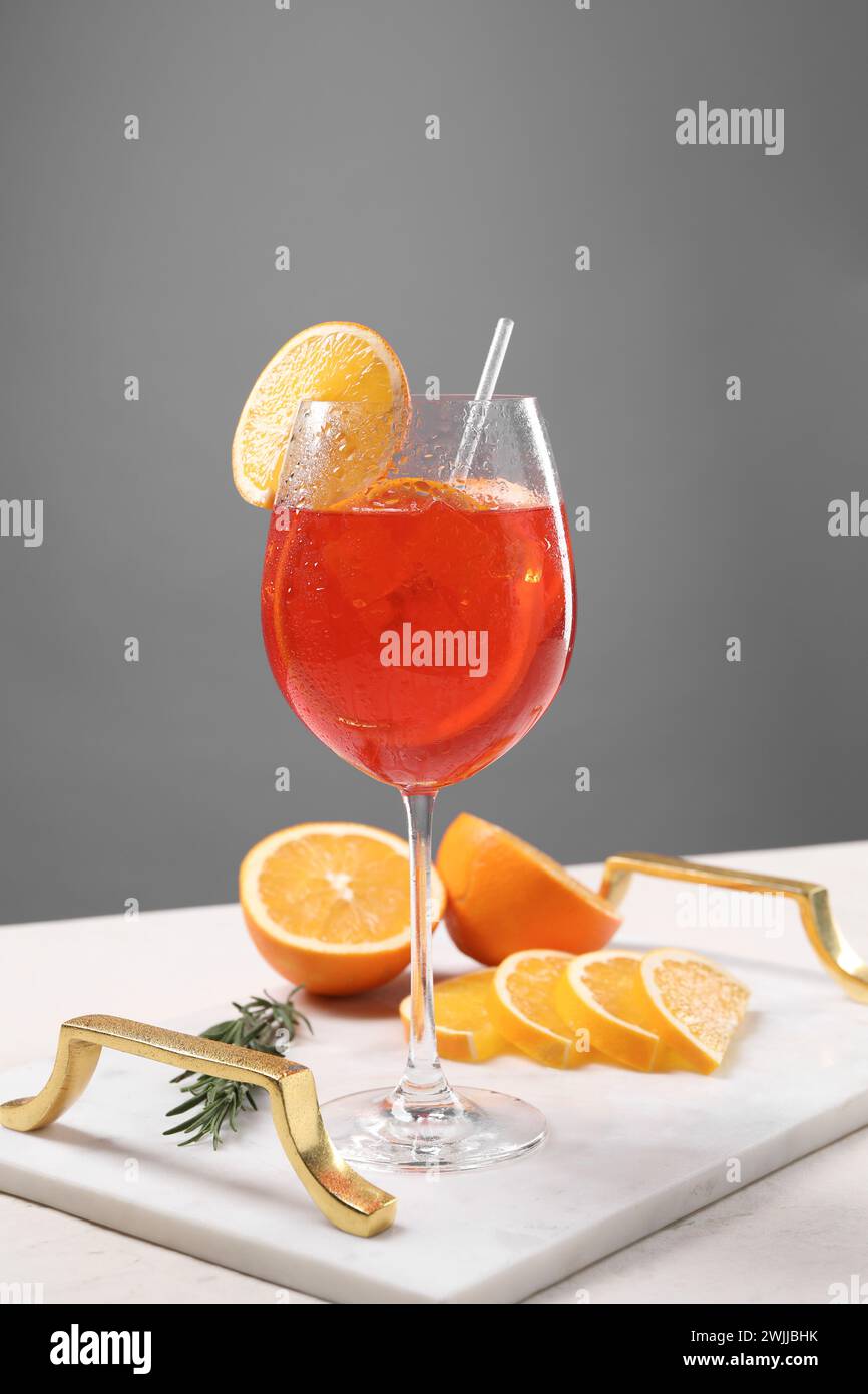 Glass of tasty Aperol spritz cocktail with orange slices and rosemary ...