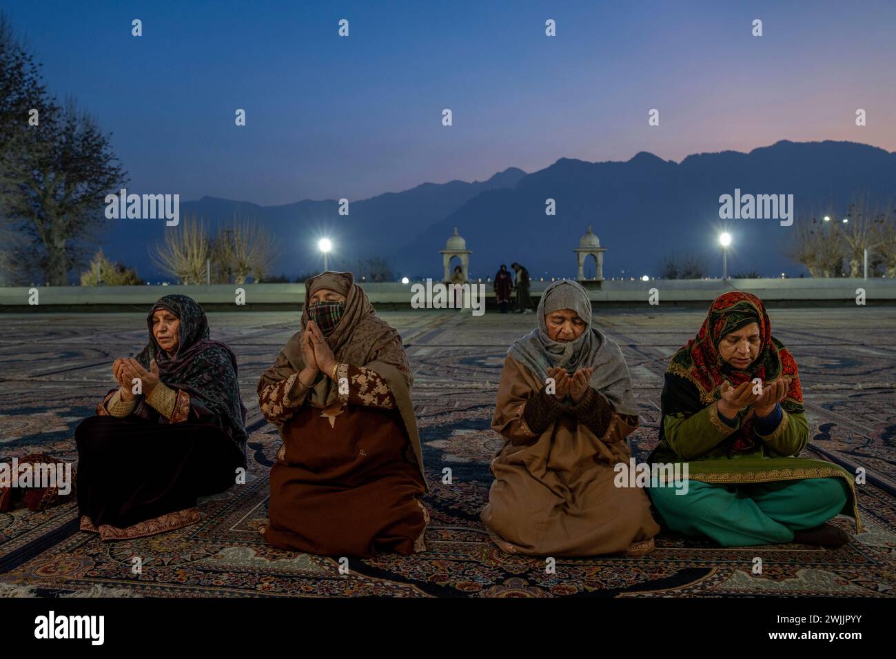 Kashmiri Muslim women pray outside the Hazratbal Shrine in Srinagar ...