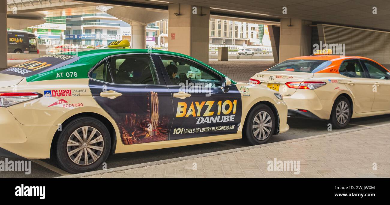 Dubai Taxi cars Toyota Camry in the city street. Taxis parked at downtown of Dubai. Public Dubai transport. January 26,20214 Stock Photo
