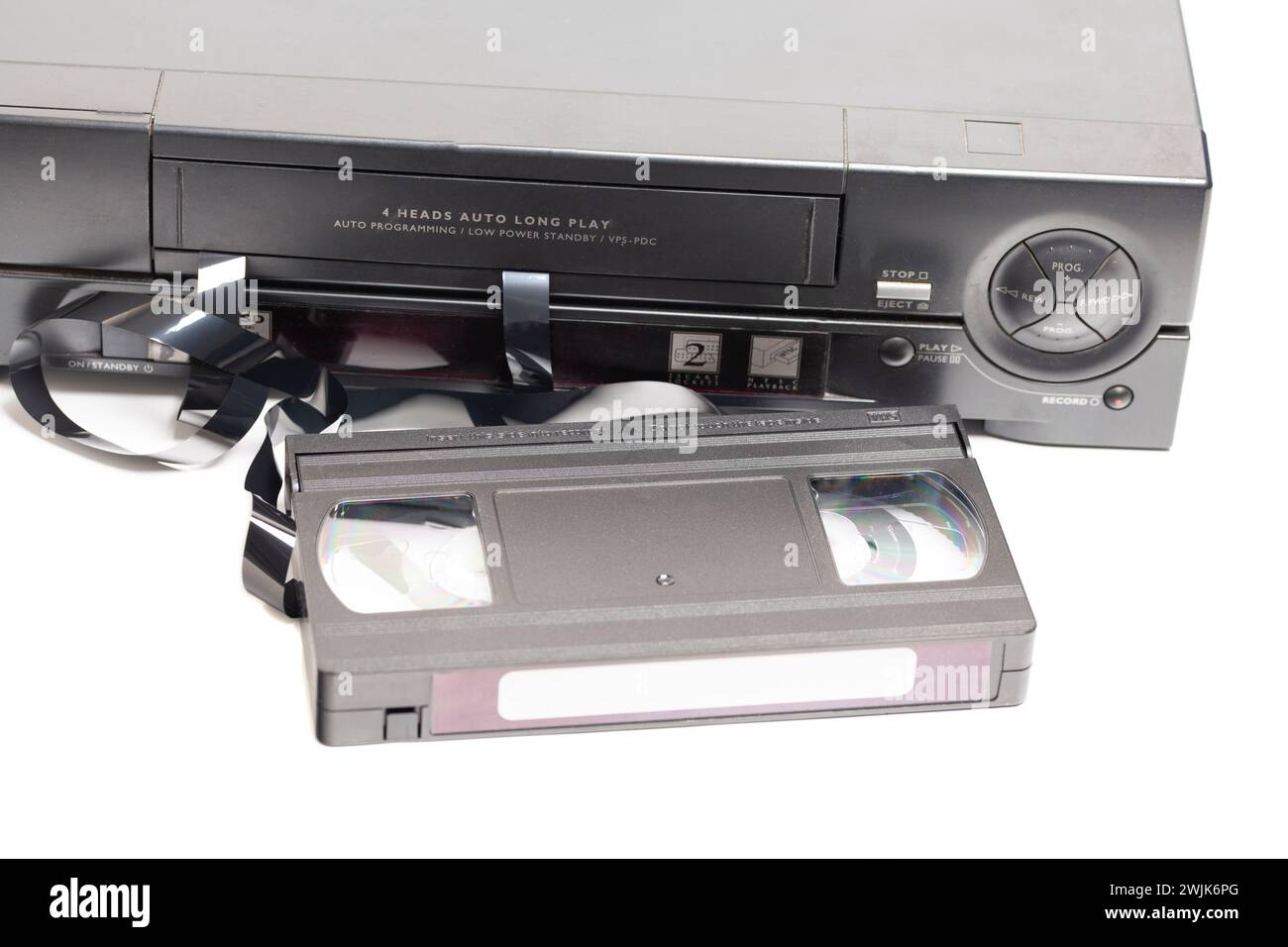 Retro video cassette recorder with VHS cassette with unwound tape ...