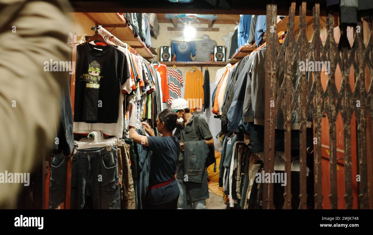 Immersed in the thrifting culture of Sambu, Medan city, every corner tells a tale of treasures found, a vibrant community bonded by vintage allure Stock Photo