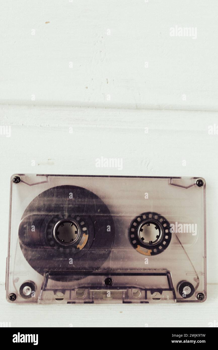 Old audio tape on white background. Retro audio format. Cassette tapes. 90's nostalgia concept. Old fashioned lifestyle. Archival objects. Stock Photo
