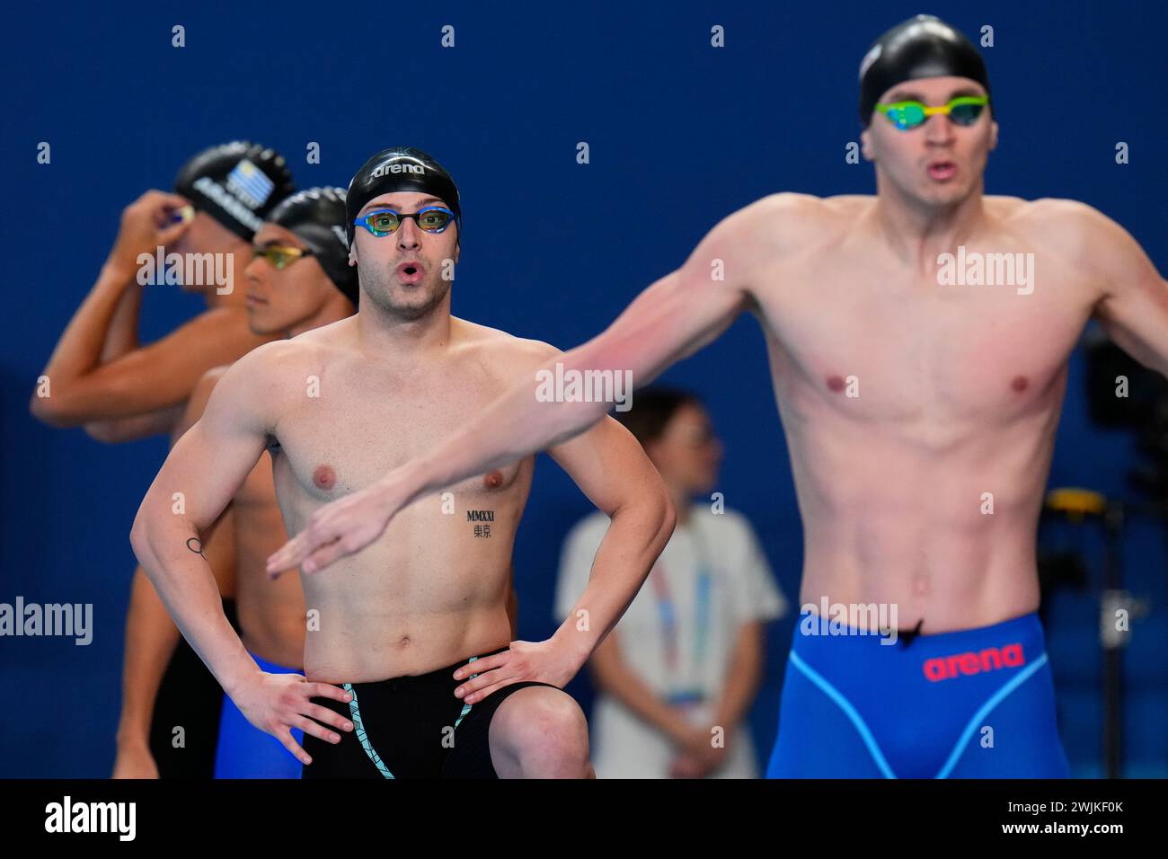 Swimmers prepare to compete in the men's 50meter freestyle heat at the