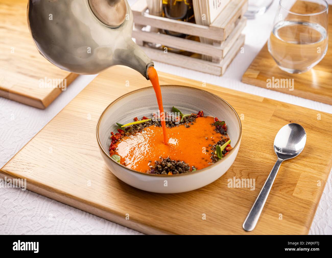 Grilled sweet pepper cream soup served with black lentil Stock Photo