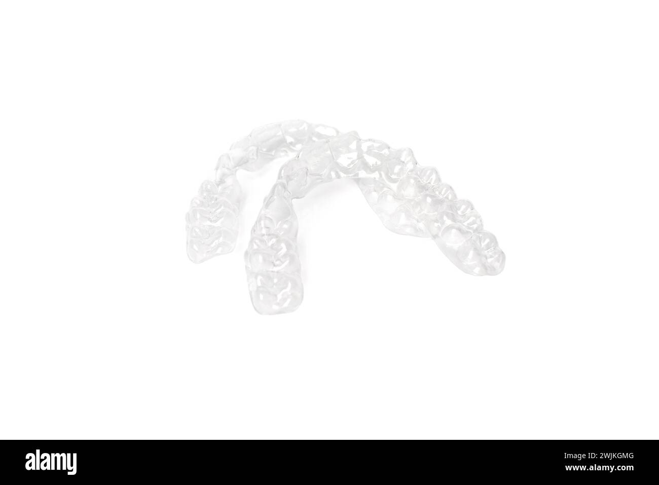 Tooth aligners, invisible orthodontics cosmetic brackets on white background, plastic braces. Modern teeth retainers created on a 3d printer. A way to Stock Photo