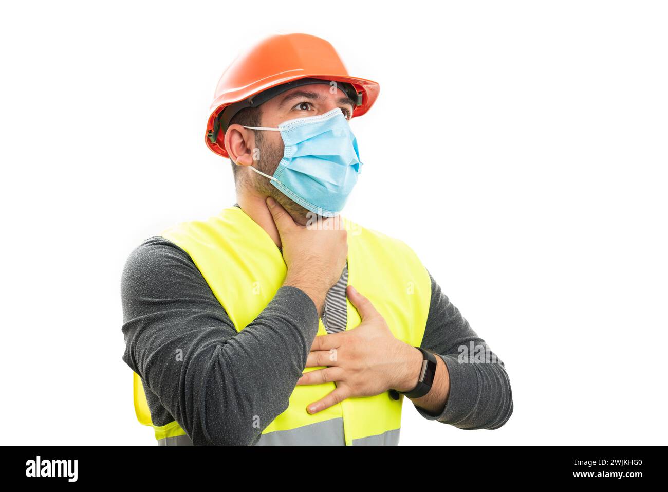 Adult builder man wearing medical or surgical mask to prevent sars covid19 flu infection making choking gesture isolated on white studio background Stock Photo