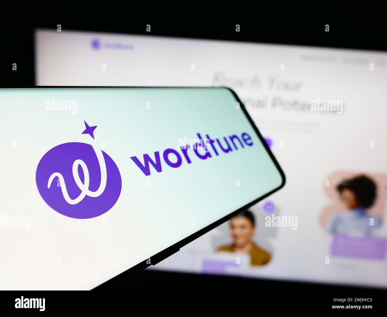 Mobile phone with logo of artificial intelligence companion Wordtune (AI21 Labs) in front of business website. Focus on left of phone display. Stock Photo