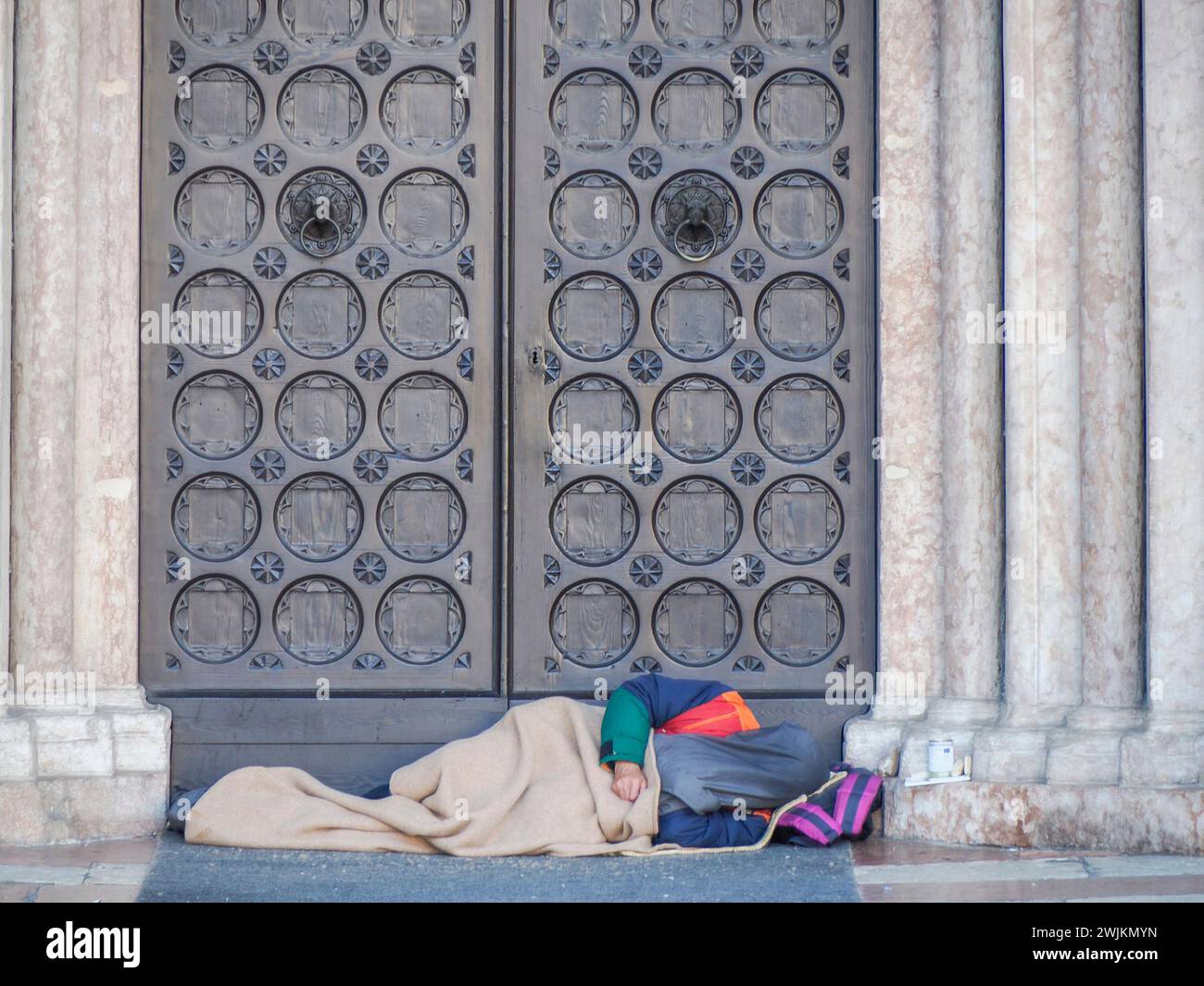 Medieval Homeless An Homeless tramp sleeping outside entrance of the Medieval Cathedral ...