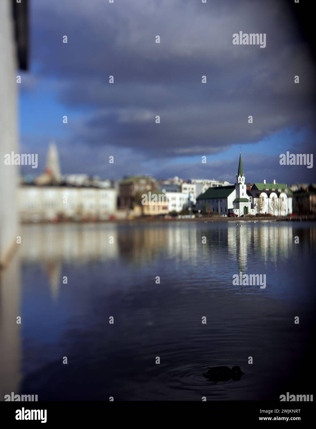 A body of water with buildings in the background Stock Photo